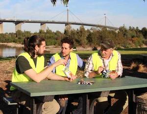 Volunteer workers try out the new public furniture at Melbourne's Westgate Park, made from recycled packaging from The Natural Confectionery Company (TNCC) range and a selection of Cadbury Dairy Milk products.